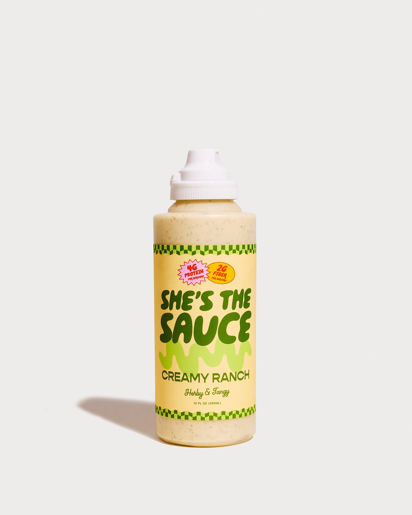 Bottle of She's the Sauce Creamy Ranch on a light grey background